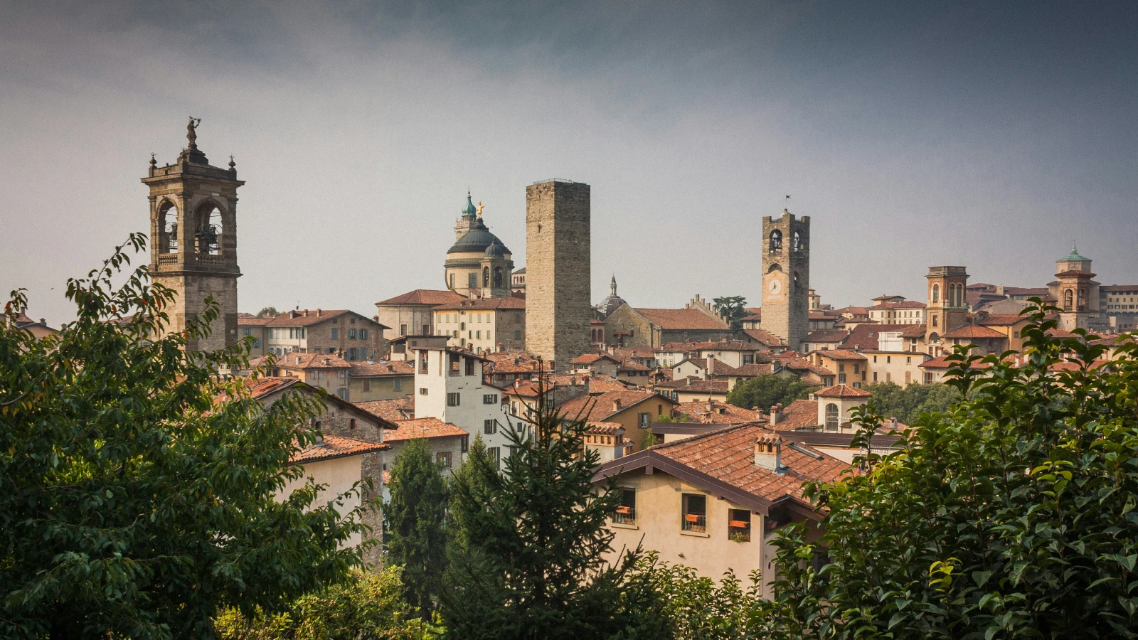 Historic white and brown building in Bergamo old town accessible by rental car